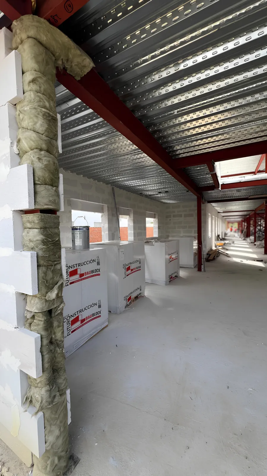 BAUBLOCK materials beside AAC wall construction and insulated structural interfaces on an active building project.